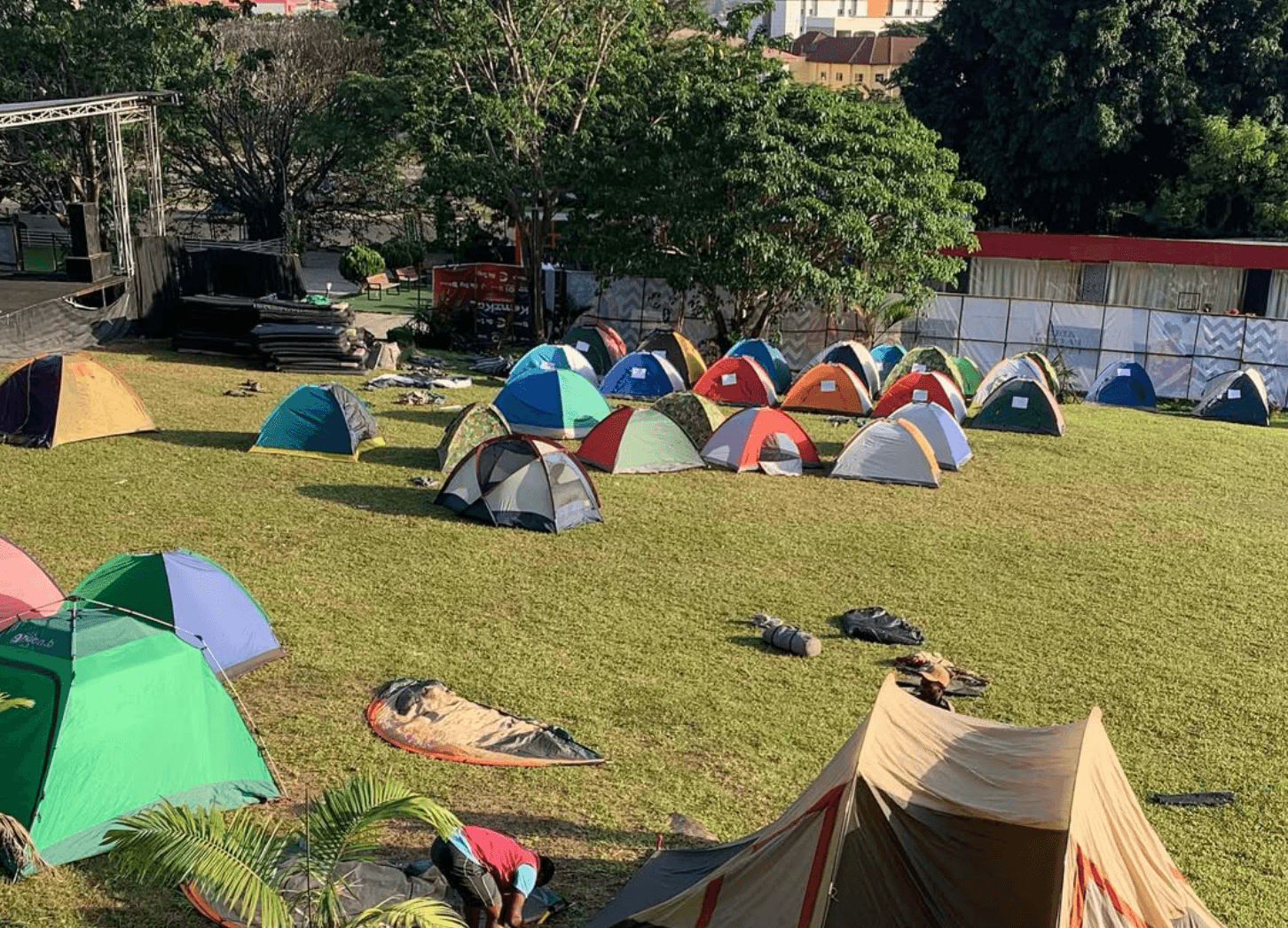 Premium camping gear and tent setup in a forest clearing