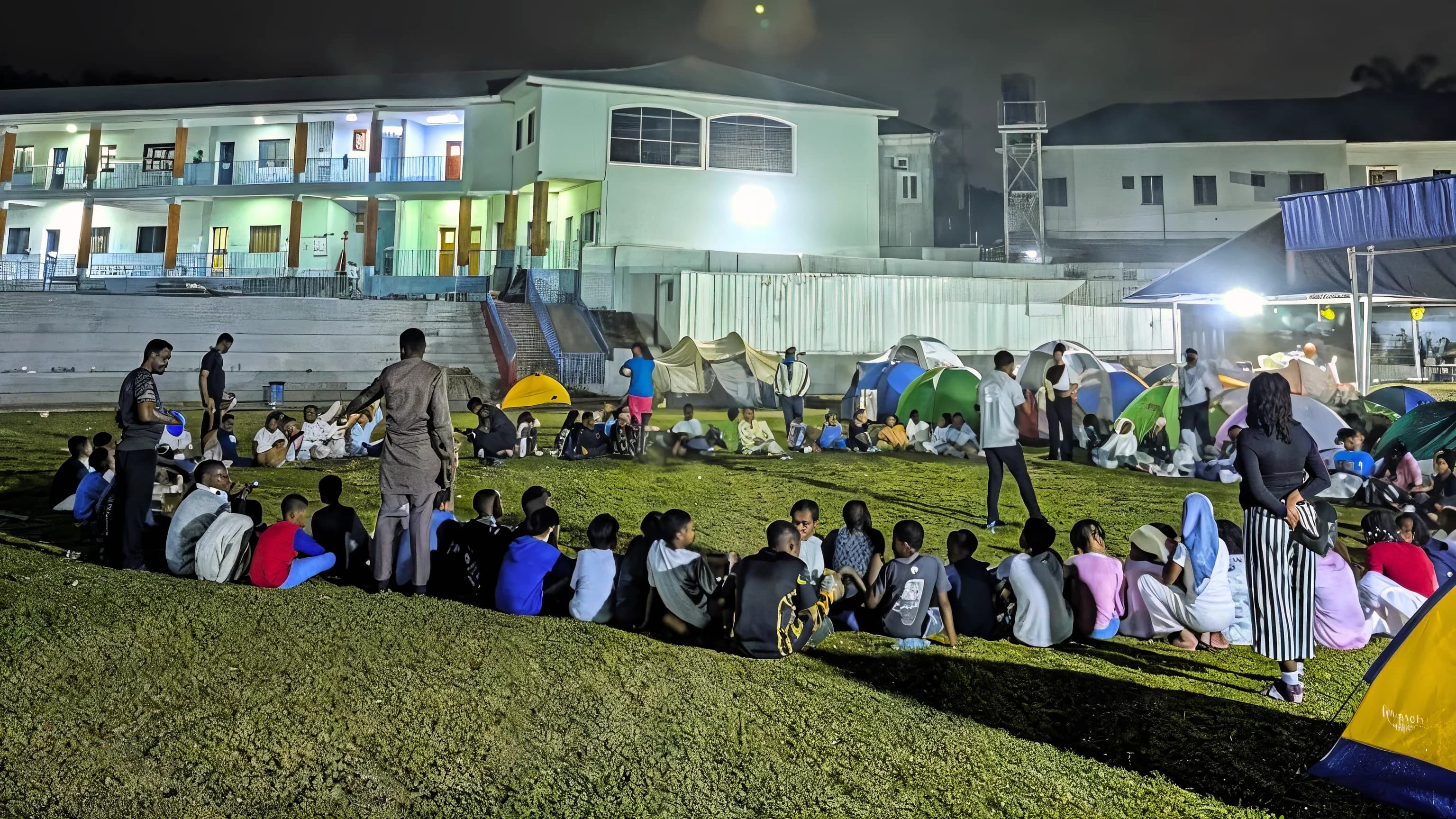 Students gathered around a campfire during an outdoor learning expedition